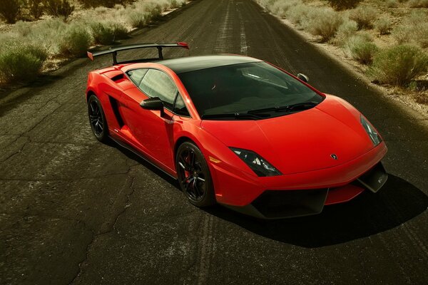 A red lamborghini on an empty road