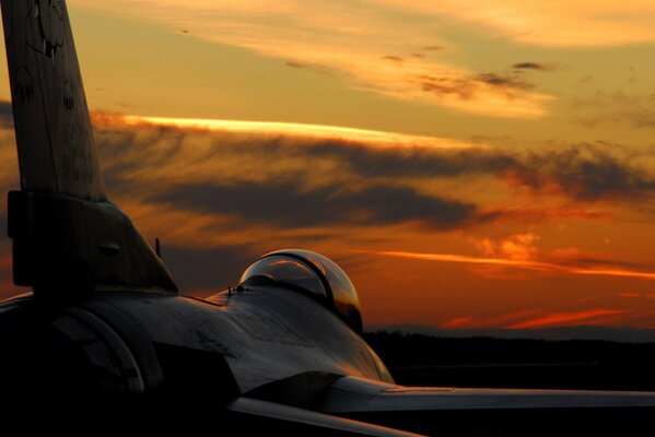 The fighter flies beautifully at sunset