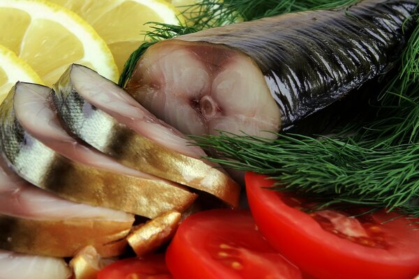 Salted fish, sliced, surrounded by lemon, tomato and dill