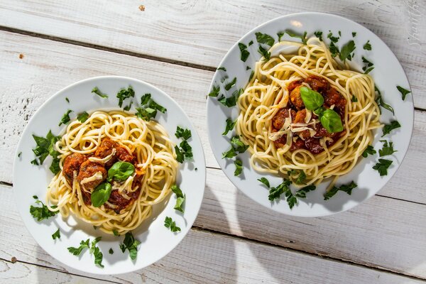 Spaghetti Bolognese mit Kräutern in Tellern