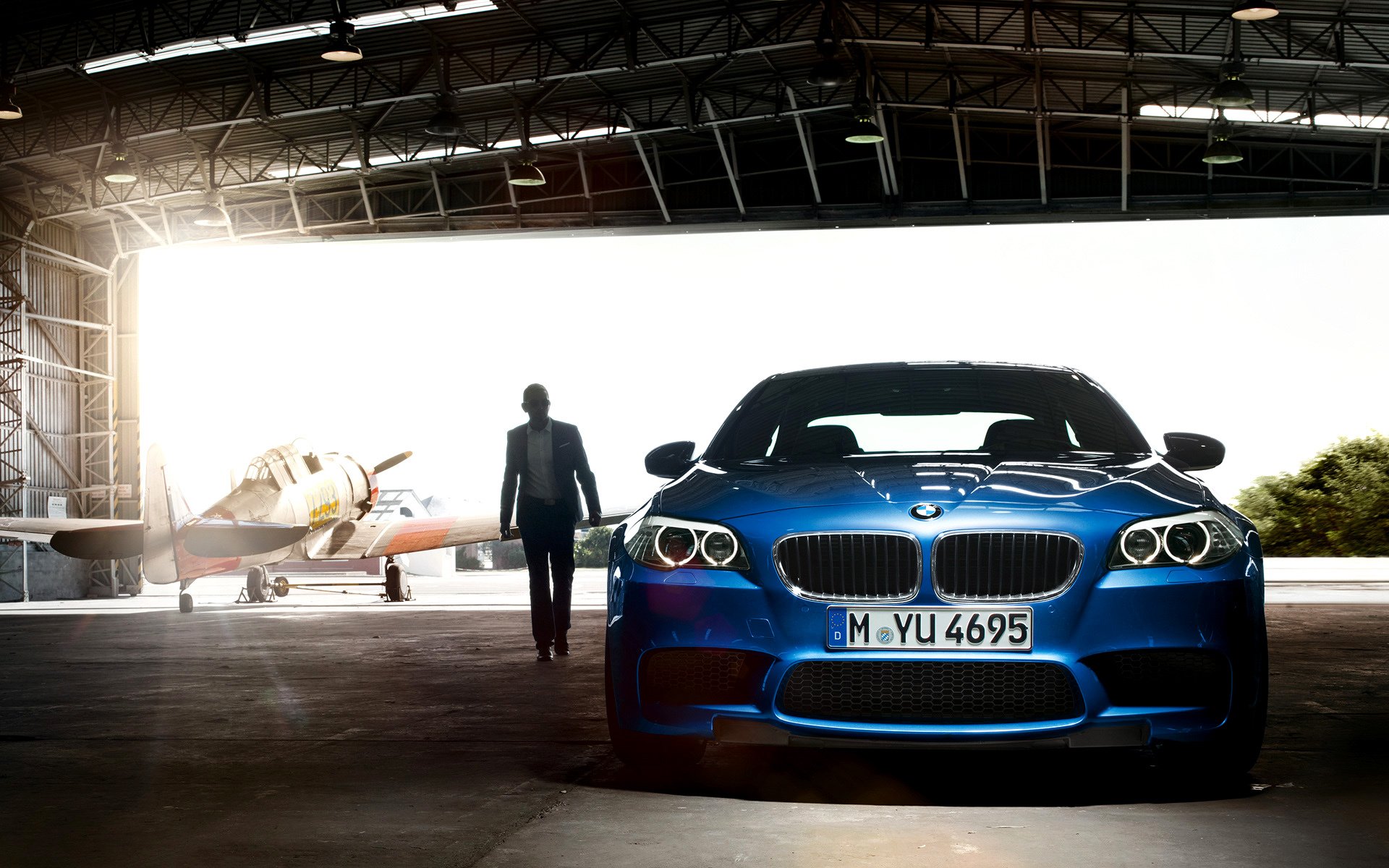 bmw m5 2011 car hangar man airplane light car airplane 1920x1200