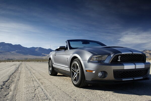 Ford convertible car on the background of mountains