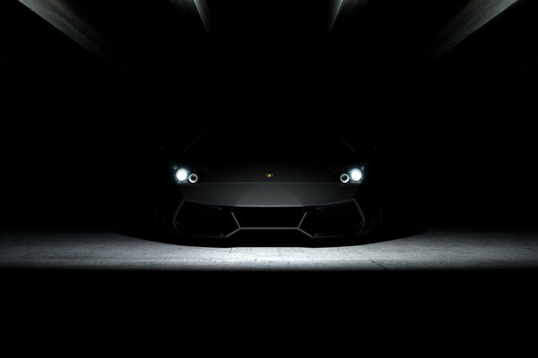 Screensaver black Lamborghini with burning headlights