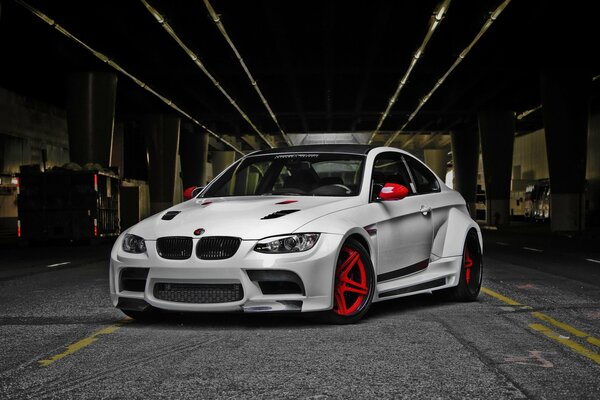 White stylish car on the background of a dark tunnel 