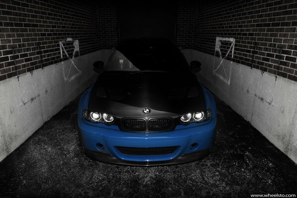 A blue car coming out of an underground garage