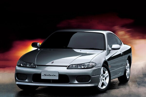 Glossy gray Nissan on a fiery background