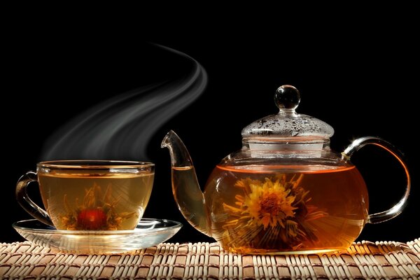 Hot flower tea in a glass teapot