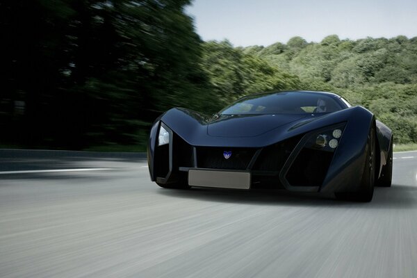 The marussia b2 sports car is flying along the highway at speed