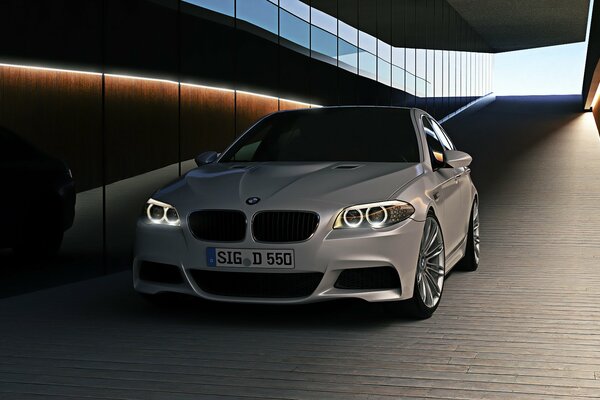 White BMW m5 in an underground tunnel