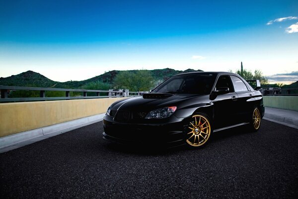 Sports car on the background of the road and the sky