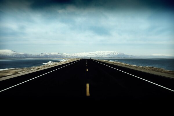 Black road on the background of mountains