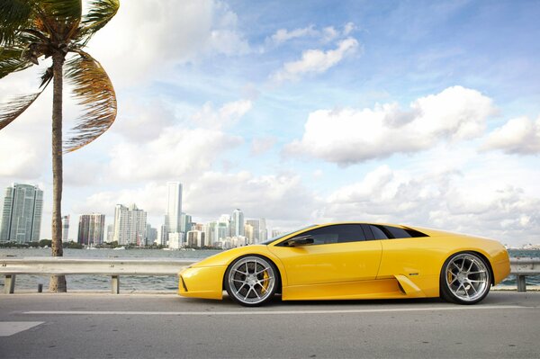 Yellow Lamborghini on the background of the blue sky of the city of Miami