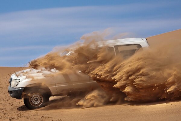 The car pulls out of the sand