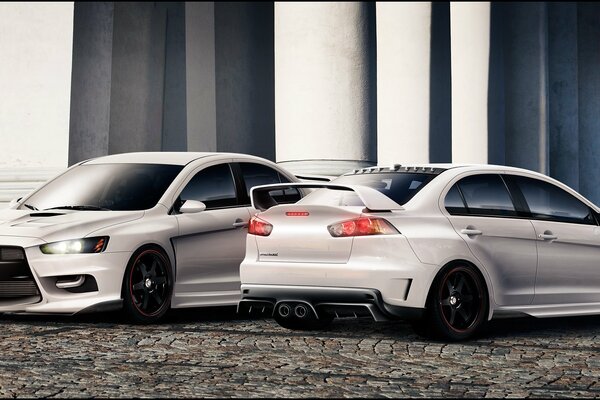 Two cars on the background of a white building with columns