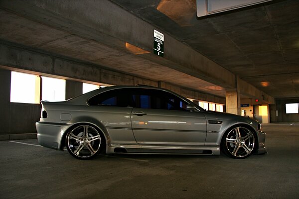 A gray BMW car standing in the parking lot