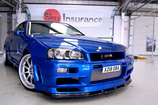 Blue Nissan car in a bright interior