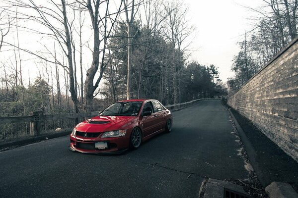 Red Lancer on the background of wet asphalt