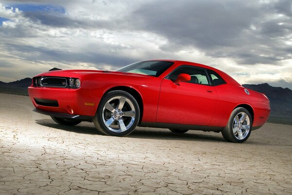 Red car in the desert at night