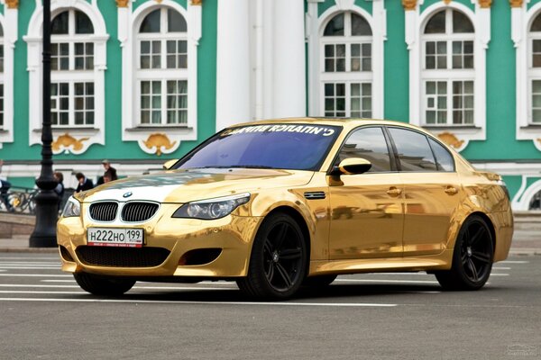 A stunningly golden bmw stands beautifully 