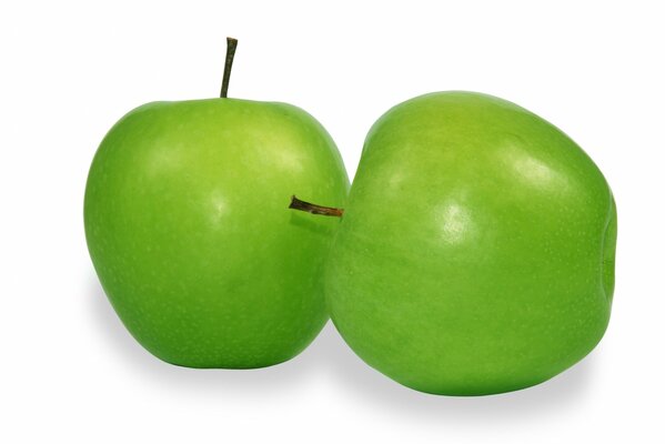 Two green apples on a white background