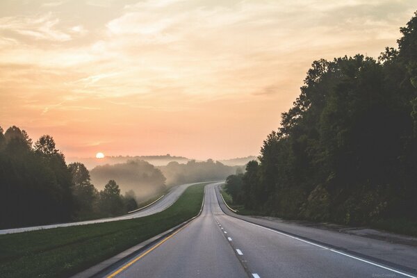 The road stretching away behind the sun