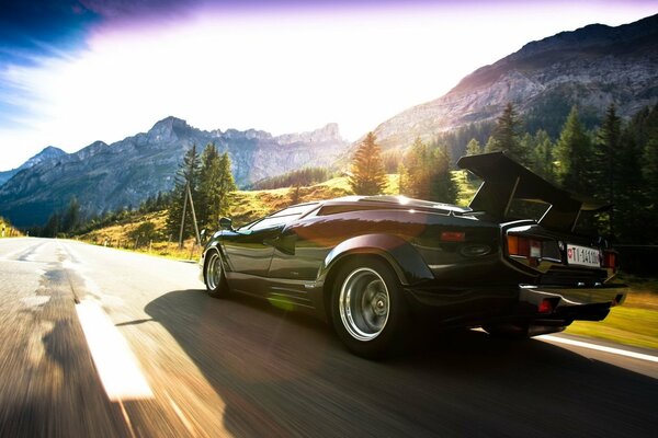 Lamborghini rushes along the highway among the mountains