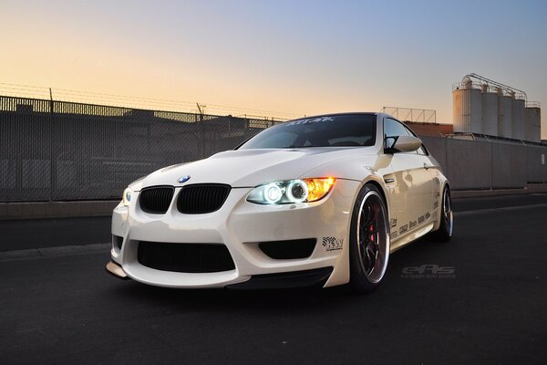 White BMW on the background of the industrial zone 