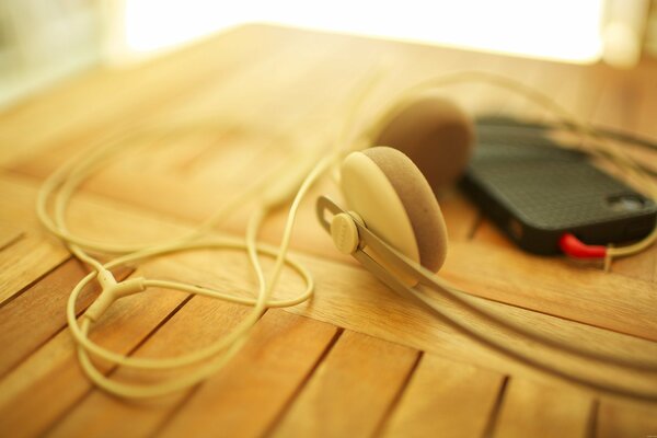 White headphones for the player with a red adapter