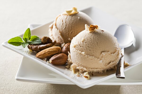 Ice cream balls with nuts on a saucer