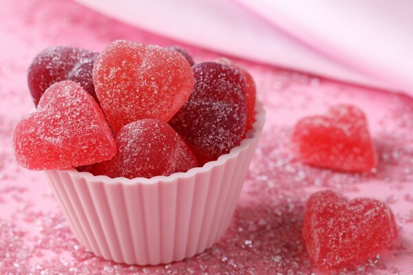 Strawberry red marmalade in the form of hearts in a cupcake mold