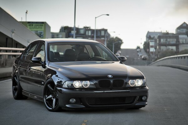 BMW negro en el puente de la ciudad