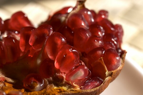 Broken ripe pomegranate on a plate