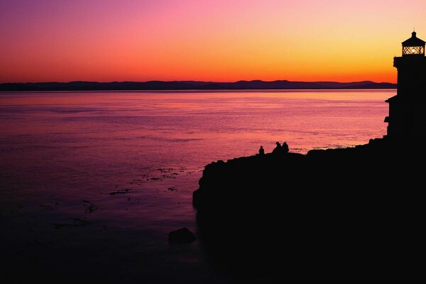 How beautiful the view of the sea and the lighthouse are at sunset