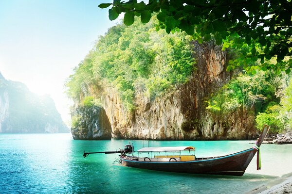 Boat on the shore of the azure sea