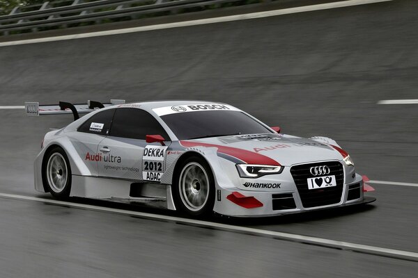 Silver Audi on the race track at speed