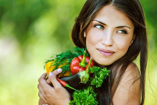 A girl with vegetables and a gorgeous smile