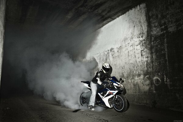 Suzuki motorcycle skids with a lot of smoke