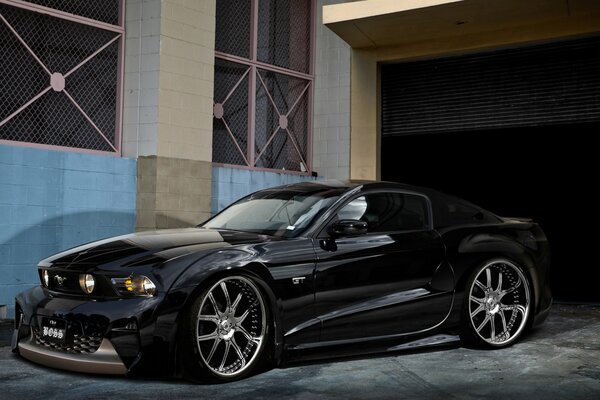 Ford Mustang drives out of the garage