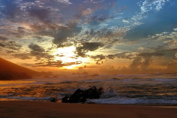 Stunning sunset on the background of waves