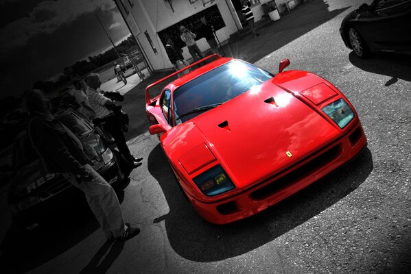 Ferrari F40 rojo sobre fondo negro y gris