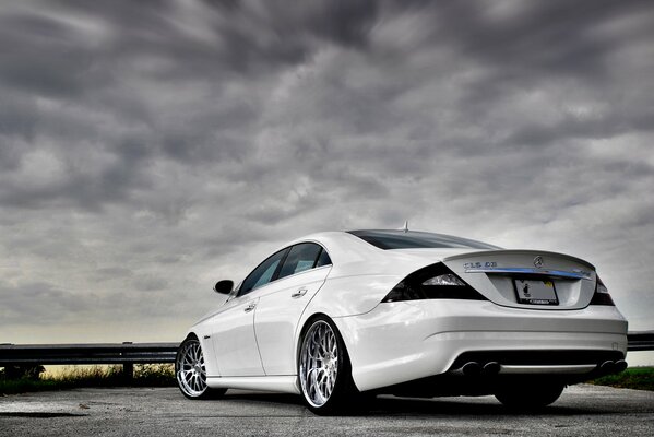 Tuned Mercedes Benz on a gray sky background