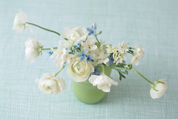 A delicate little bouquet in a green vase