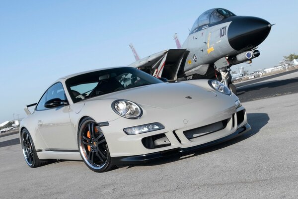 Sports car on the background of a fighter plane