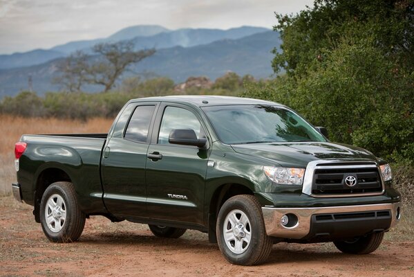 Toyota Pickup steht vor dem Hintergrund der Berge