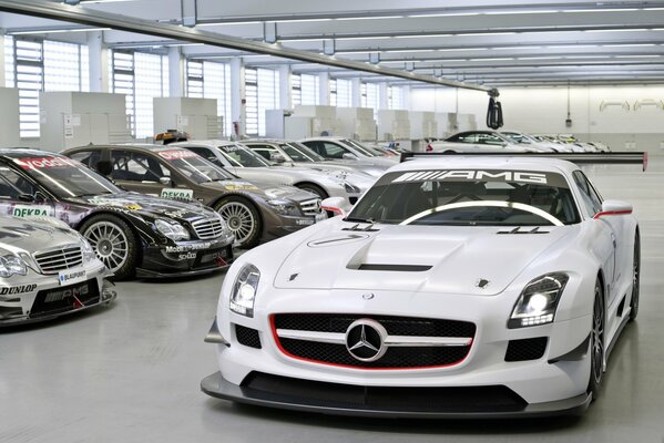White Mercedes in the garage with other sports cars