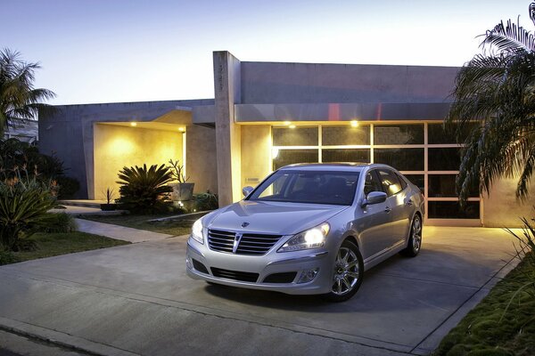 The car is parked at home near the garage