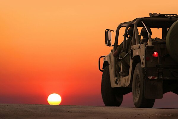 A military vehicle on the background of sunset