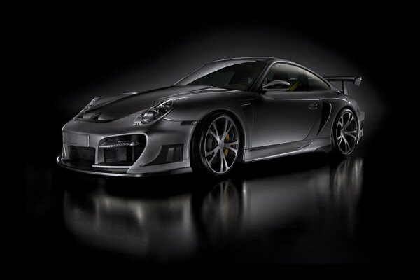 A black car with beautiful wheels on a black background