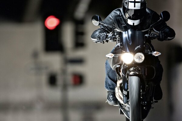 A rider in a helmet on a motorcycle focuses attention on himself