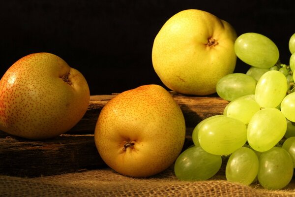 Photo for still life. Three pears and a bunch of grapes